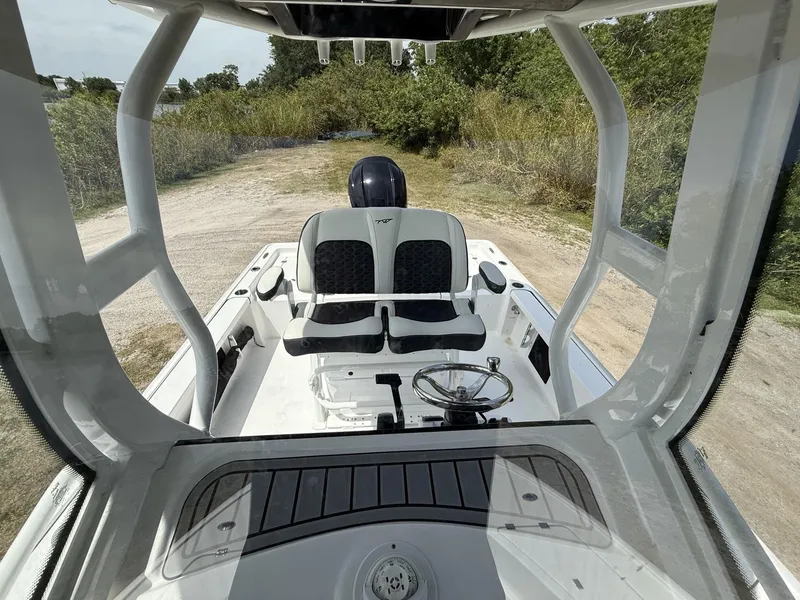 Slide: The Image of 2024 Tidewater 2410 Bay Max boat interior with dual seats and steering wheel. - 15