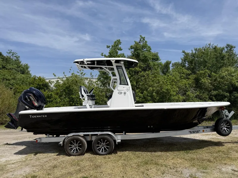Slide: The Image of 2024 Tidewater 2410 Bay Max boat on trailer, parked outdoors. - 2