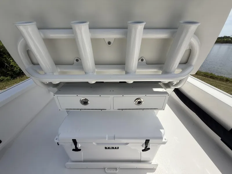 Slide: The Image of 2024 Tidewater 2410 Bay Max boat with rod holders and Yeti cooler on deck. - 21