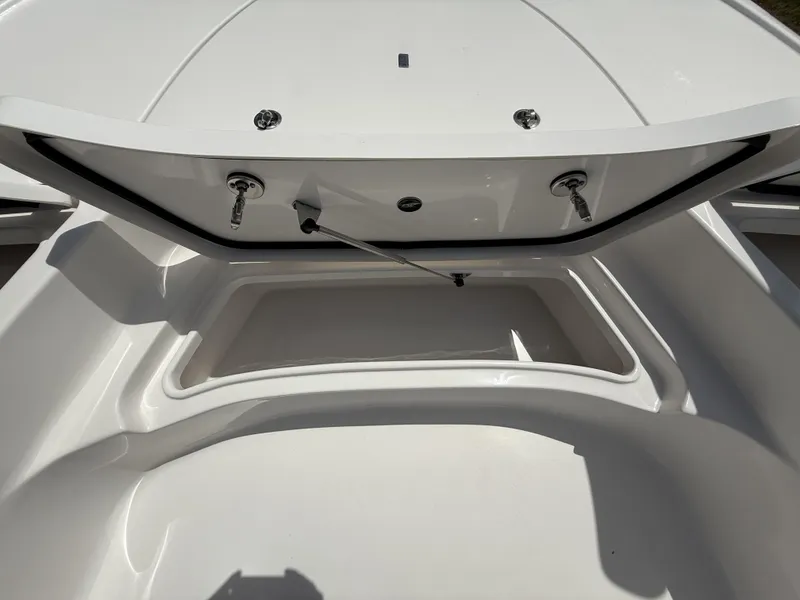Slide: The Image of 2024 Tidewater 2410 Bay Max boat storage compartment, open and empty. - 26