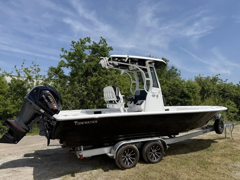 Slide: The Image of 2024 Tidewater 2410 Bay Max boat on trailer, parked outdoors under clear sky. - 3