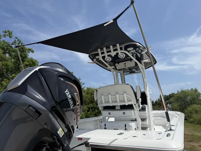 Slide: The Image of 2024 Tidewater 2410 Bay Max boat with Yamaha engine, featuring a canopy and seating. - 30