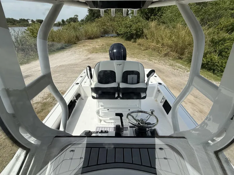 Slide: The Image of 2024 Tidewater 2410 Bay Max boat interior with steering wheel and seating. - 37