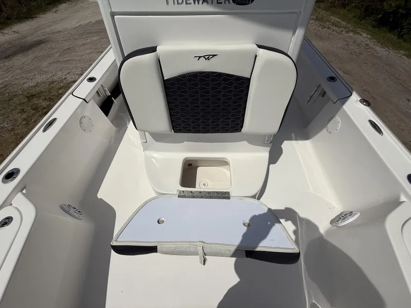 Slide: The Image of 2024 Tidewater 2410 Bay Max boat interior with seating and storage compartment. - 42