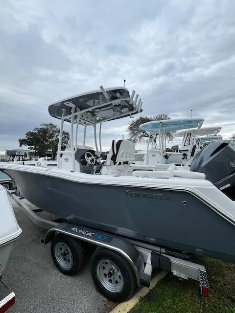 Slide: The Image of 2024 Tidewater 220 LXF boat on a trailer under cloudy skies. - 14
