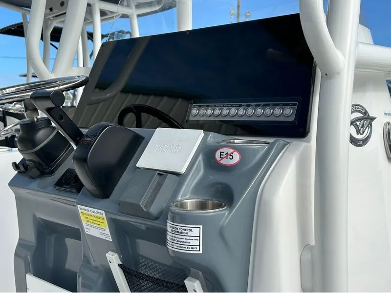 Slide: The Image of 2024 Tidewater 220 LXF boat dashboard with steering wheel and control panel. - 15