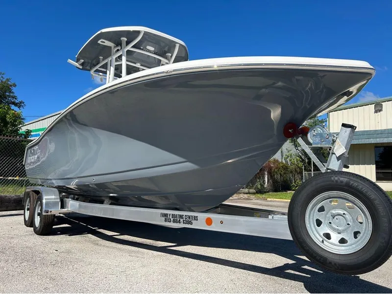 Slide: The Image of 2024 Tidewater 220 LXF boat on trailer under clear blue sky. - 18
