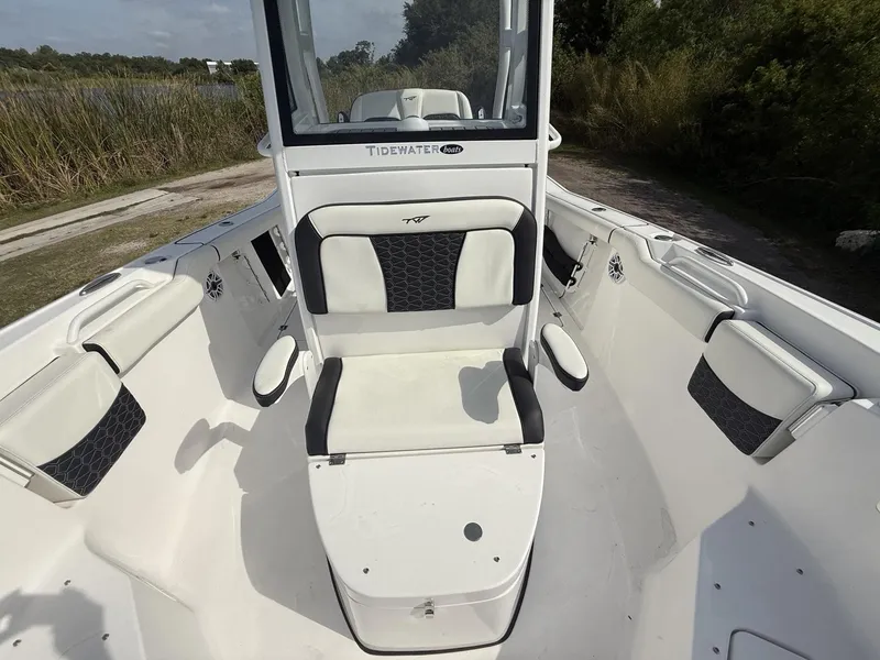 Slide: The Image of 2024 Tidewater 256 CC Adventure boat interior with cushioned seating and sleek design. - 22