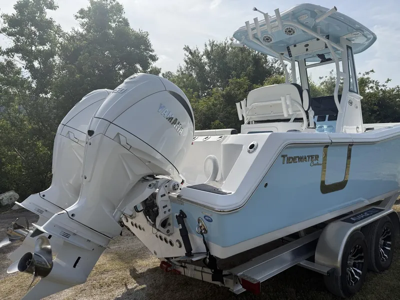 Slide: The Image of 2024 Tidewater 256 CC Adventure boat with dual Yamaha engines on a trailer. - 5