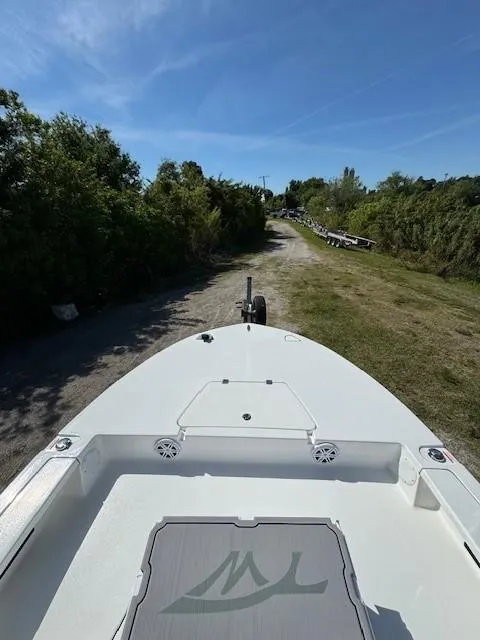 Slide: The Image of 2024 Tidewater 23 TPC RAPTOR boat on a trailer, surrounded by greenery. - 10