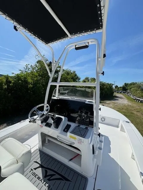 Slide: The Image of 2024 Tidewater 23 TPC RAPTOR boat interior with steering console and canopy. - 13
