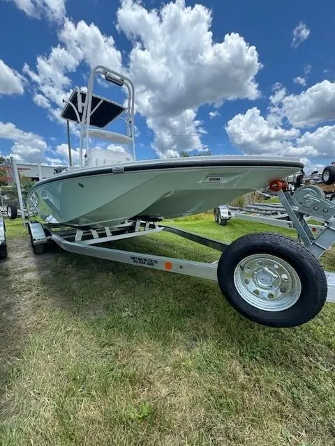 Slide: The Image of 2024 Tidewater 23 TPC RAPTOR boat on trailer under a blue sky with clouds. - 18