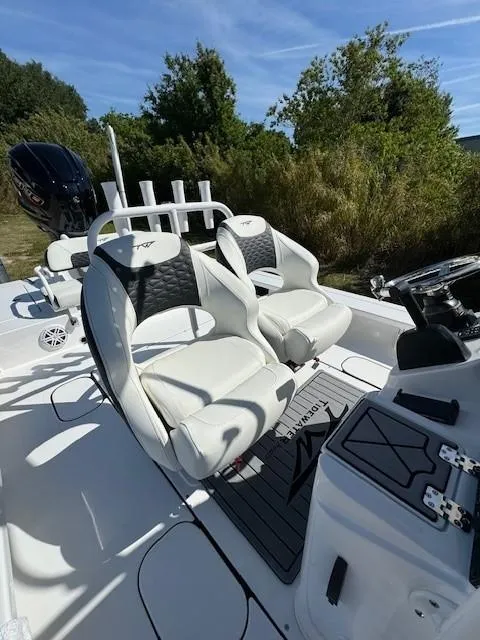 Slide: The Image of 2024 Tidewater 23 TPC RAPTOR boat interior with white seating and console. - 6