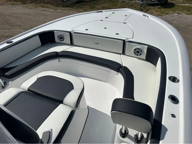 Slide: The Image of 2025 Tidewater 2700 Carolina Bay boat interior with cushioned seating and speakers. - 17