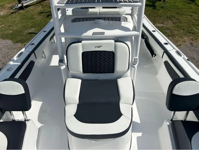 Slide: The Image of 2025 Tidewater 2700 Carolina Bay boat interior with white and black seating. - 19