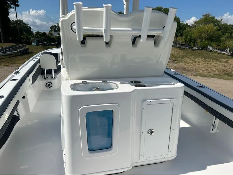Slide: The Image of 2025 Tidewater 2700 Carolina Bay boat interior with rod holders and storage compartments. - 2