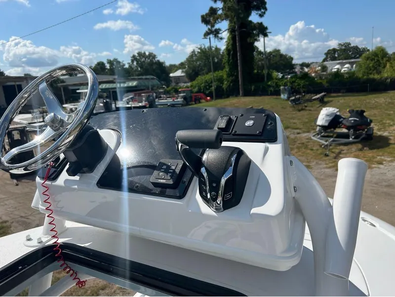 Slide: The Image of Control console of 2025 Tidewater 2700 Carolina Bay boat with steering wheel and throttle. - 20