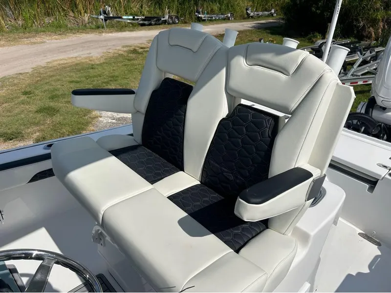 Slide: The Image of 2025 Tidewater 2700 Carolina Bay boat seats with black and white upholstery. - 21