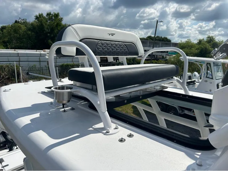 Slide: The Image of 2025 Tidewater 2700 Carolina Bay boat seat with cup holder under cloudy sky. - 22