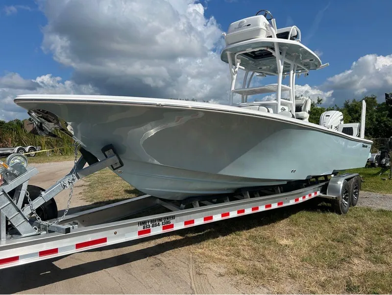 Slide: The Image of 2025 Tidewater 2700 Carolina Bay boat on trailer under cloudy sky. - 23