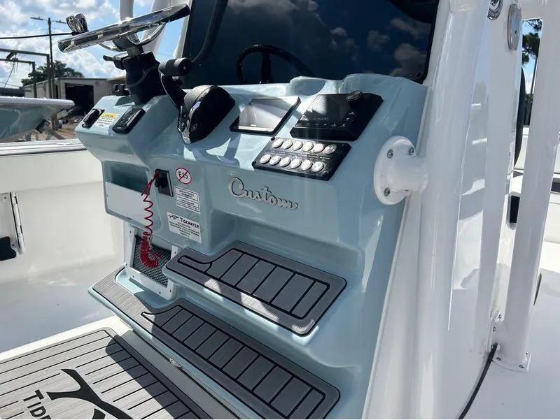 Slide: The Image of Control console of 2025 Tidewater 2700 Carolina Bay boat with steering wheel and instrument panel. - 5