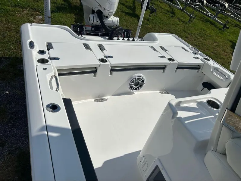 Slide: The Image of 2025 Tidewater 2700 Carolina Bay boat interior with storage compartments and cup holders. - 8