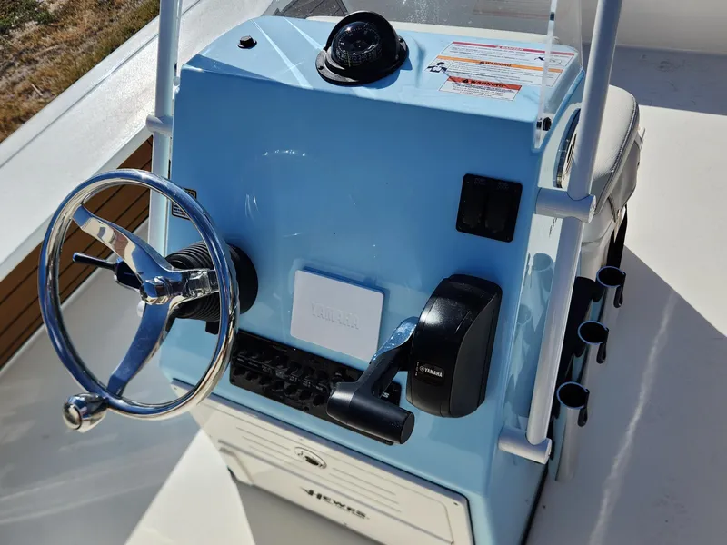 Slide: The Image of 2024 Hewes 21 REDFISHER boat console with steering wheel and Yamaha controls. - 6