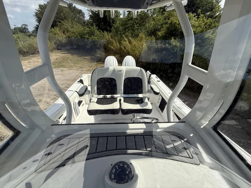 Slide: The Image of 2024 Tidewater 256 LXF boat interior with seating and dashboard view. - 12