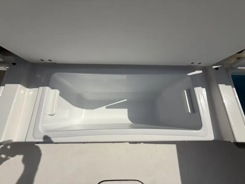 Slide: The Image of 2024 Tidewater 256 LXF boat storage compartment, open and empty. - 14