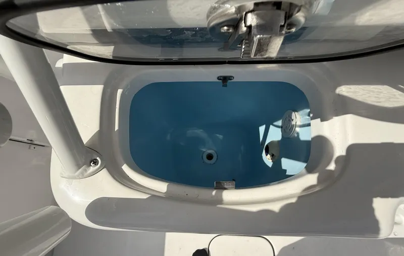 Slide: The Image of Livewell on 2024 Tidewater 256 LXF boat, featuring a clean, white interior design. - 15