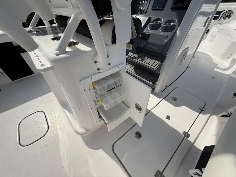 Slide: The Image of 2024 Tidewater 256 LXF boat interior with storage compartments and control panel. - 19
