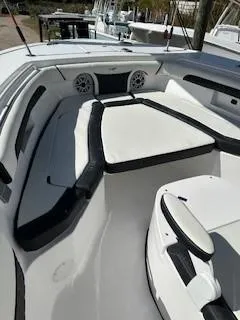 Slide: The Image of 2024 Tidewater 256 LXF boat interior with cushioned seating and modern design. - 26