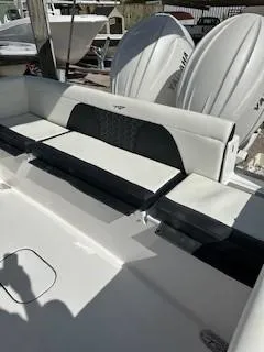 Slide: The Image of 2024 Tidewater 256 LXF boat interior with seating and dual Yamaha engines. - 28