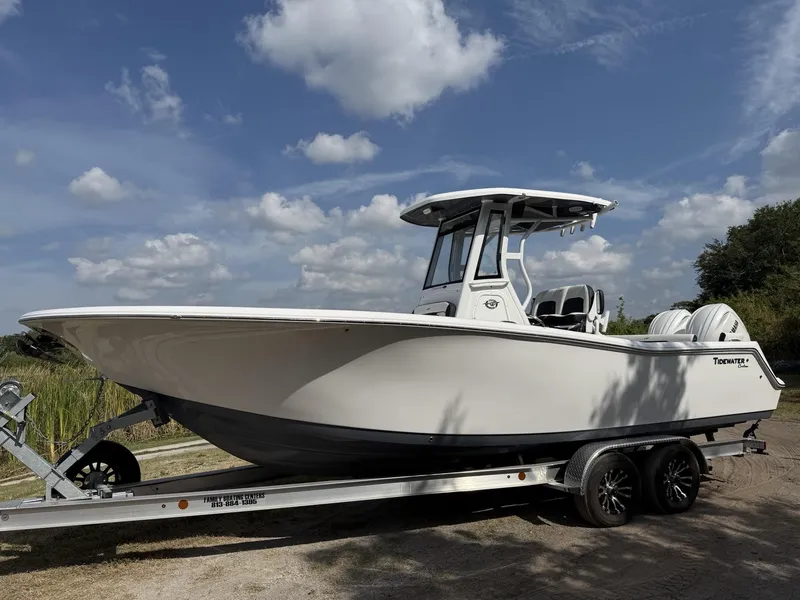 Slide: The Image of 2024 Tidewater 256 LXF boat on trailer under a partly cloudy sky. - 30