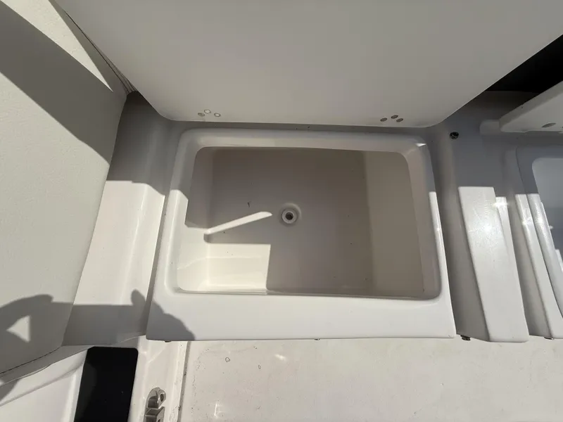 Slide: The Image of 2024 Tidewater 256 LXF boat storage compartment, open and empty. - 40