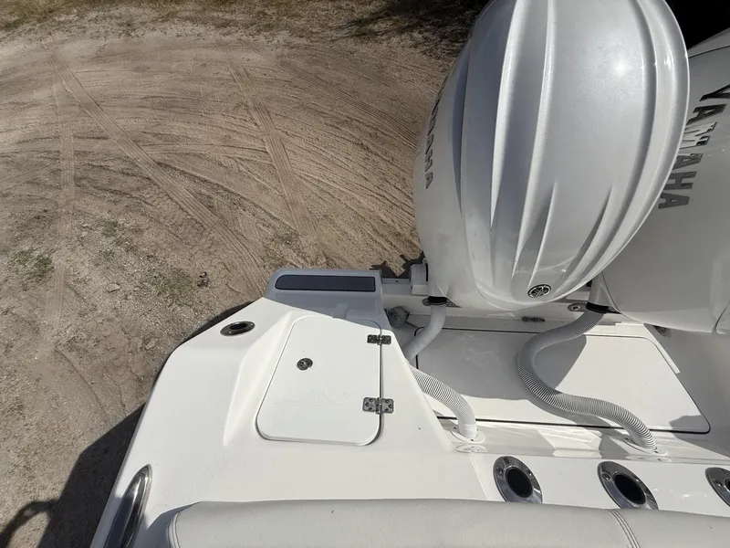 Slide: The Image of 2024 Tidewater 256 LXF boat with Yamaha engine, viewed from above on sandy terrain. - 41