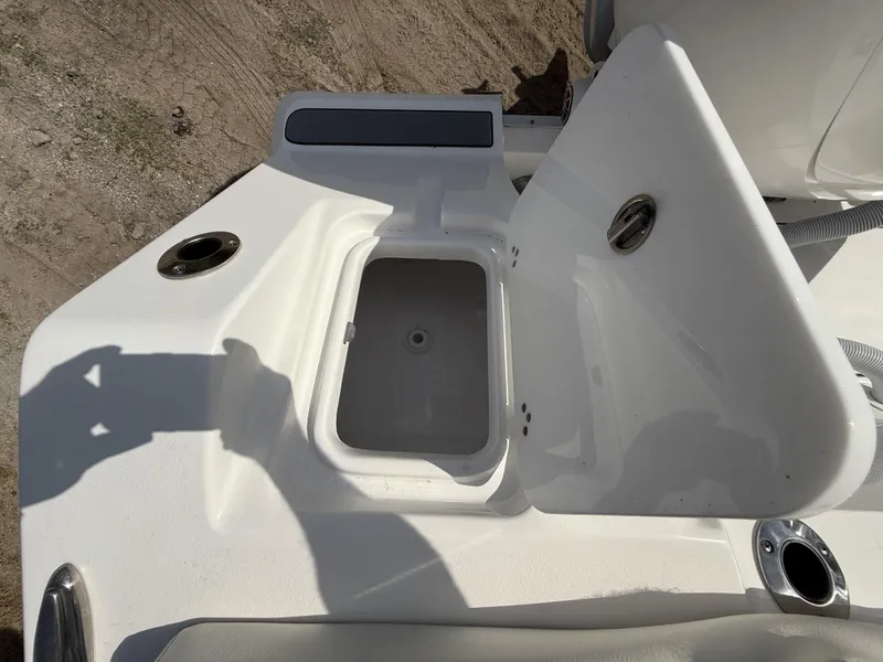 Slide: The Image of 2024 Tidewater 256 LXF boat compartment with open hatch, showcasing storage space. - 42