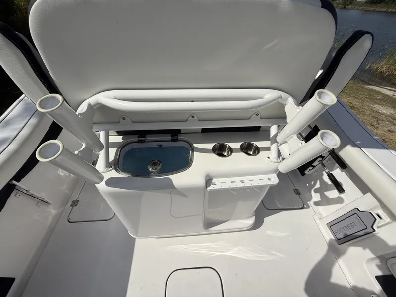 Slide: The Image of 2024 Tidewater 256 LXF boat interior with rod holders and storage compartments. - 43