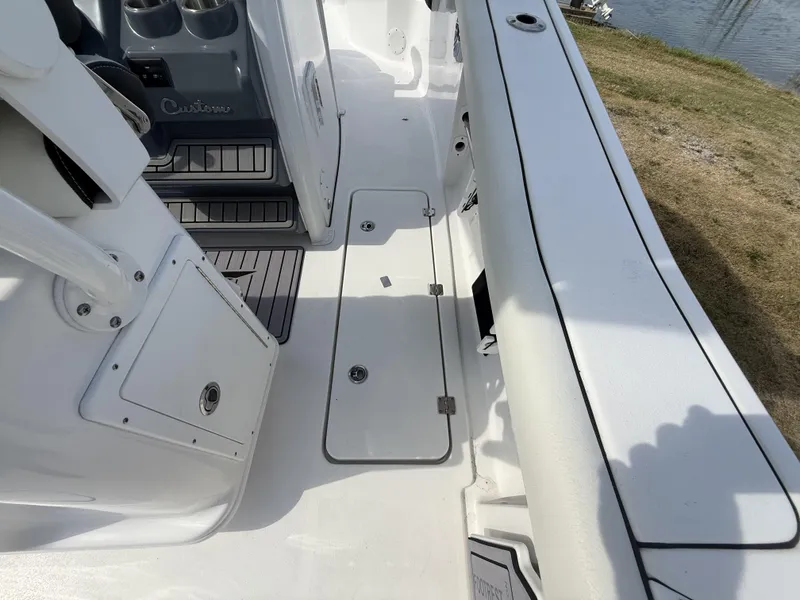 Slide: The Image of 2024 Tidewater 256 LXF boat interior with storage compartments and seating area. - 44