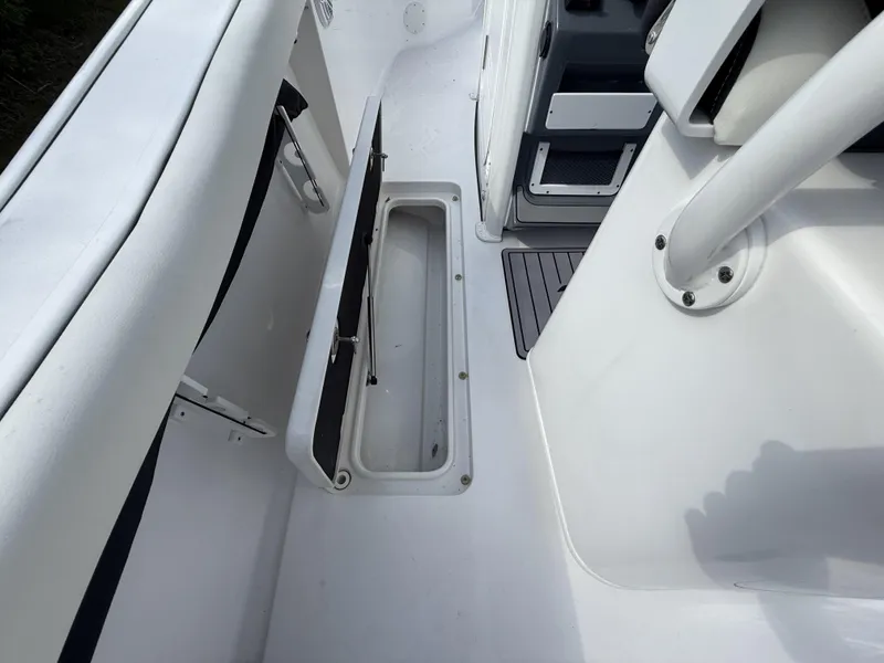 Slide: The Image of 2024 Tidewater 256 LXF boat interior with open storage compartment. - 45
