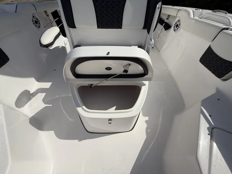Slide: The Image of 2024 Tidewater 256 LXF boat interior with open storage compartment and seating. - 49