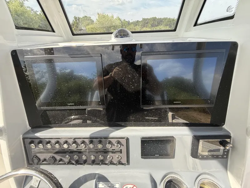 Slide: The Image of 2024 Tidewater 256 LXF dashboard with dual Garmin displays and control panel. - 9