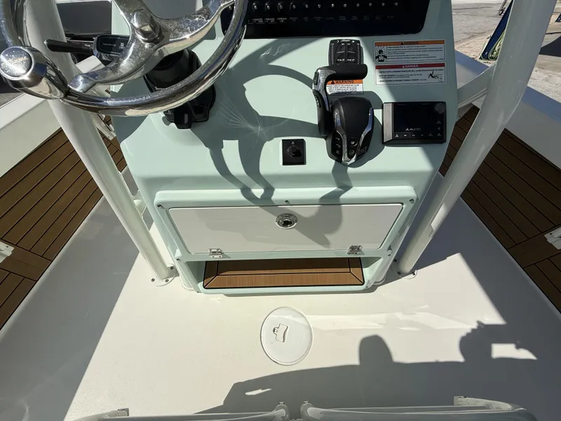 Slide: The Image of 2024 Pathfinder 2600 TRS boat console with steering wheel and controls. - 19