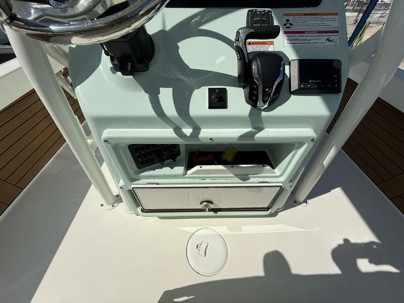 Slide: The Image of 2024 Pathfinder 2600 TRS boat console with controls and storage compartments. - 20