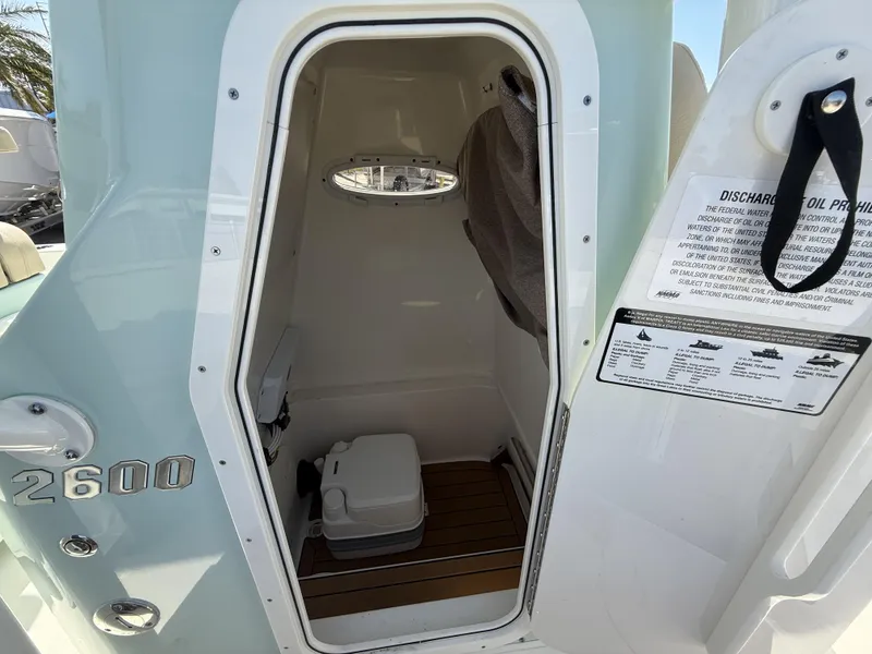 Slide: The Image of 2024 Pathfinder 2600 TRS boat interior with compact toilet and storage space. - 25