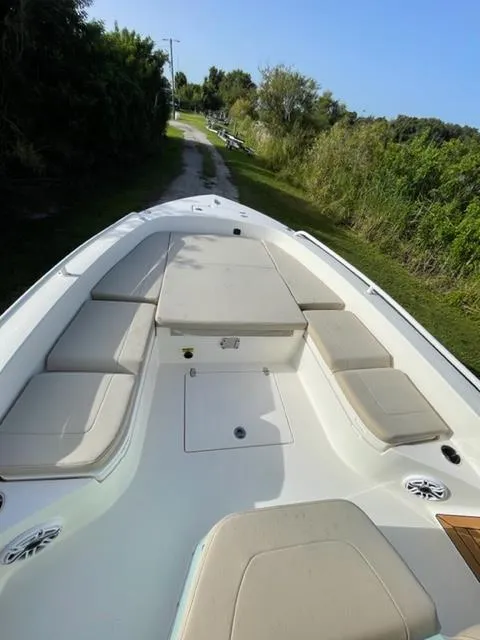 Slide: The Image of 2024 Pathfinder 2600 TRS boat with cushioned seating and storage compartments. - 30