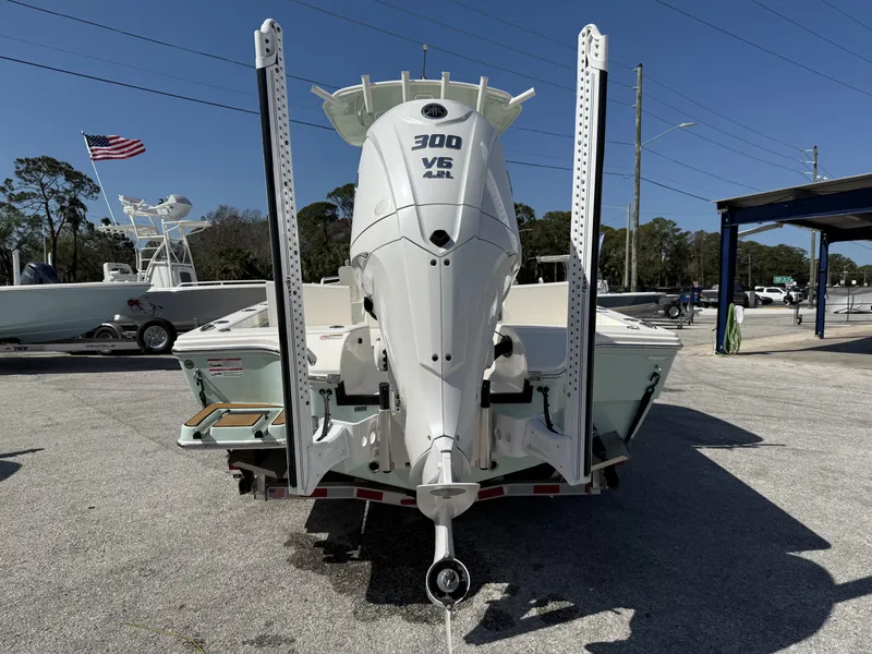Slide: The Image of 2024 Pathfinder 2600 TRS boat with powerful 300 V6 engine, parked outdoors. - 31