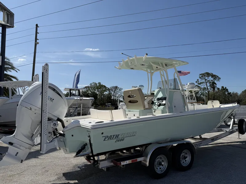 Slide: The Image of 2024 Pathfinder 2600 TRS boat on trailer, outdoor display, clear sky background. - 34