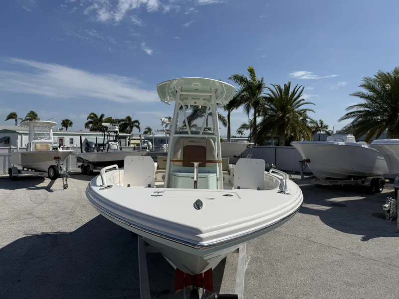 Slide: The Image of 2024 Pathfinder 2600 TRS boat displayed outdoors with palm trees and blue sky. - 36