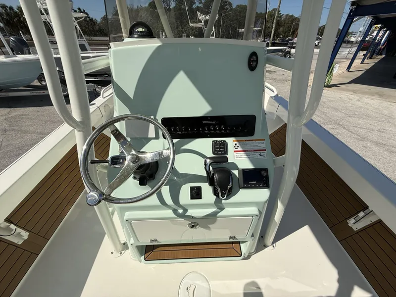 Slide: The Image of 2024 Pathfinder 2600 TRS boat console with steering wheel and controls. - 37